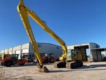Used Komatsu excavator under blue sky